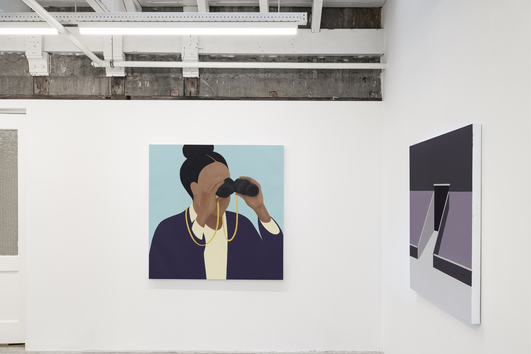 A contemporary gallery with white walls and two large paintings hanging on adjacent walls. The painting at the center of the image shows a figure with a top knot and dark-blue blazer looking through binoculars. On the adjacent wall is painting of a stadium entrance in different shades of purple and rendered in simplified geometric forms.